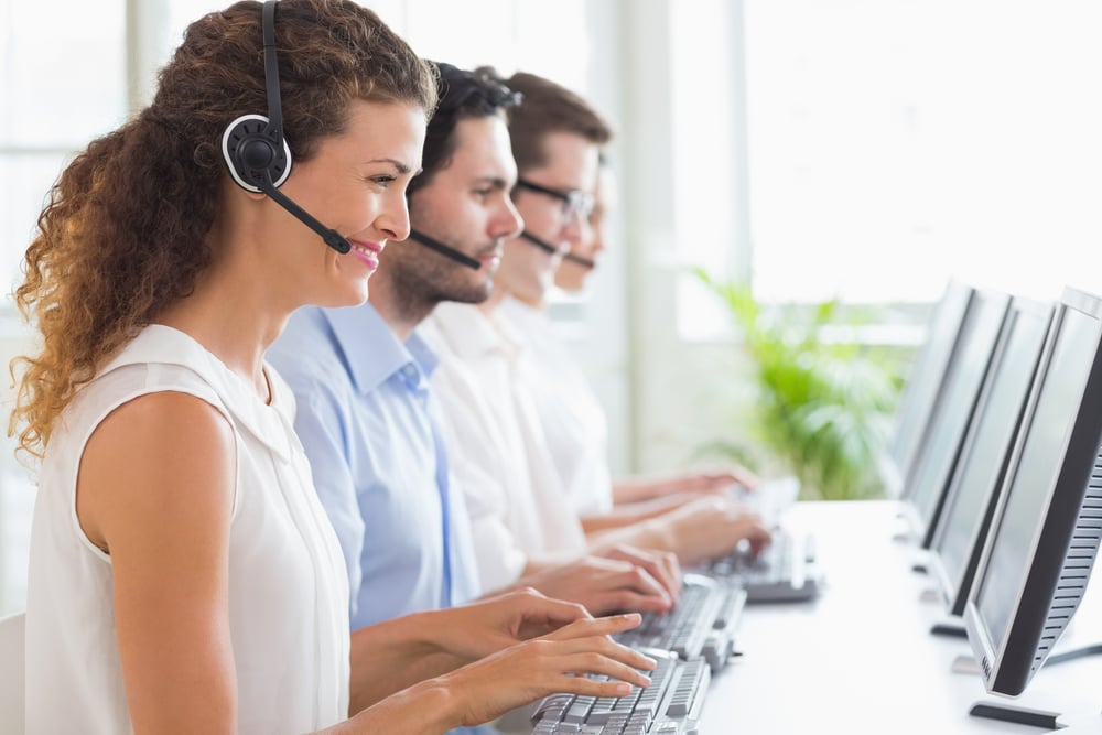 Customer service representatives working in office