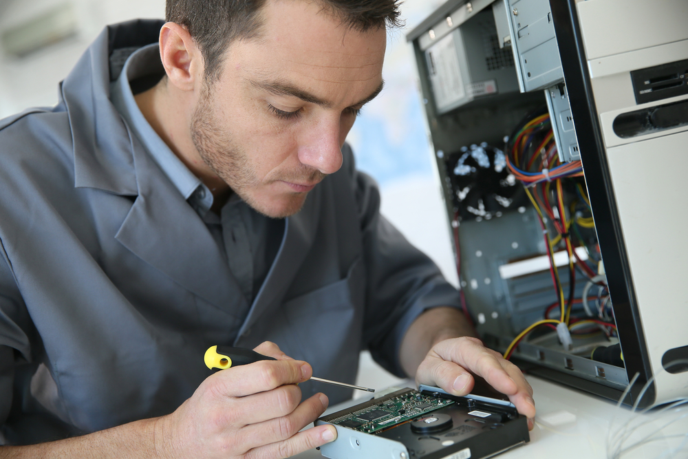 Technician fixing computer hardware