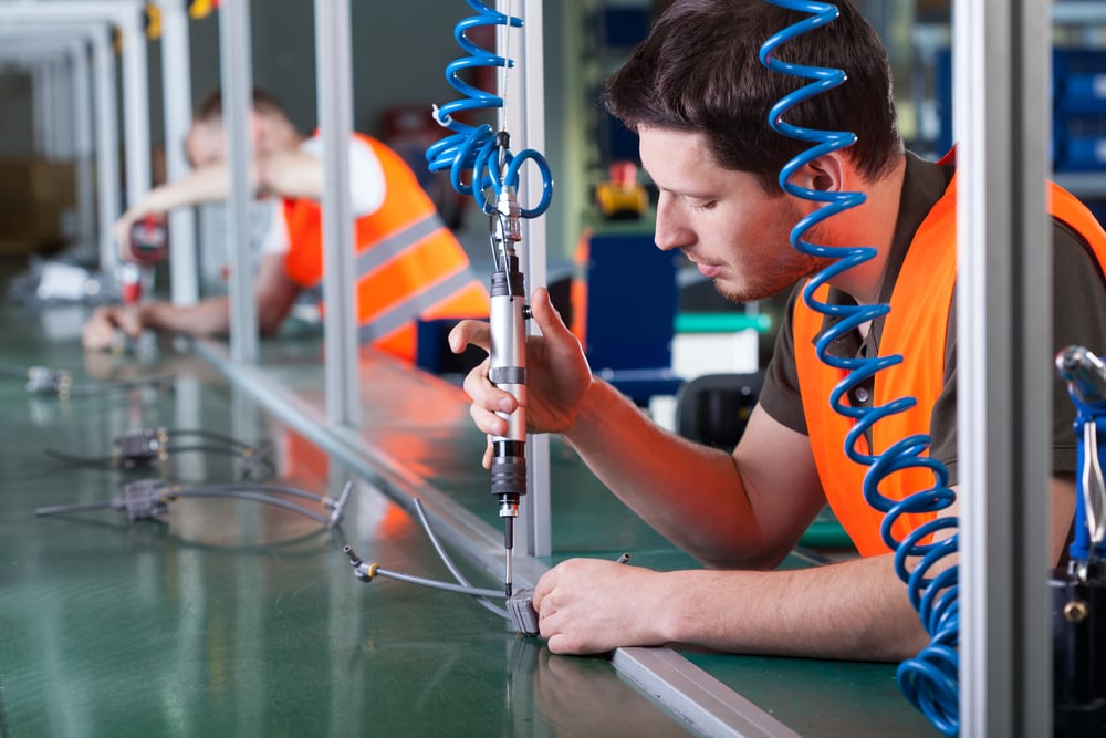 Line worker doing precision work on production line